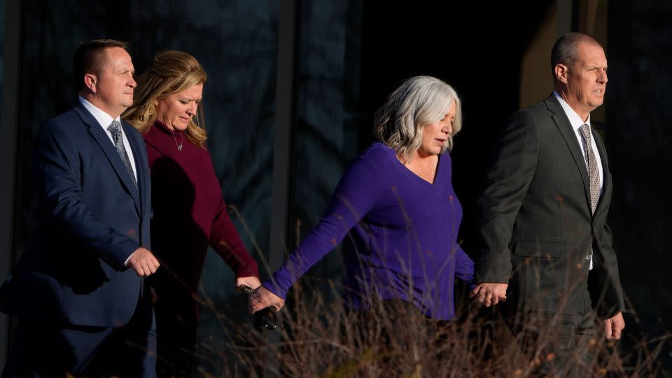 Paramedics Jeremy Cooper, far left, and Peter Cichuniec, far right, enter the Adams County, Colorado, Justice Center on December 22, 2023. - David Zalubowski/AP