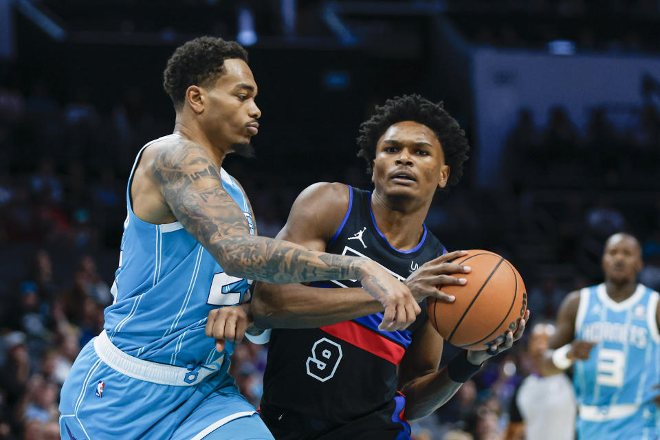 Detroit Pistons forward Ausar Thompson (9) drives against Charlotte Hornets forward P.J. Washington during the first quarter of an NBA basketball game in Charlotte, N.C., Friday, Oct. 27, 2023. (AP Photo/Nell Redmond)