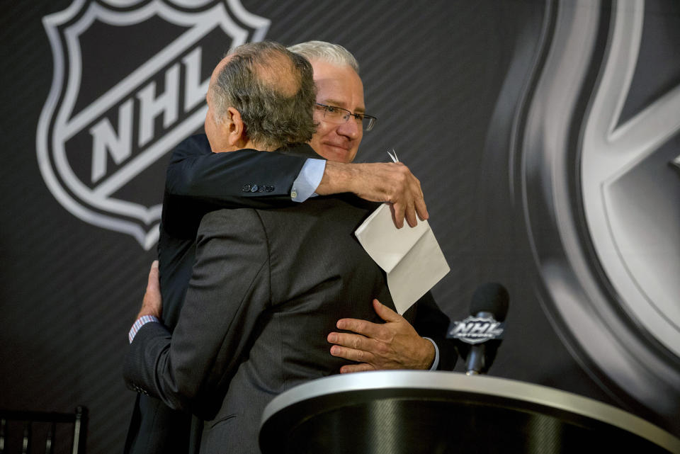 Seattle Hockey Partners president and CEO Tod Leiweke, right, is hugged by National Hockey League Commissioner Gary Bettman after the announcement by National Hockey League Board of Governors to name Seattle as the home of the league's 32nd franchise, Tuesday, Dec. 4, 2018, in Sea Island, Ga. (AP Photo/Stephen B. Morton)