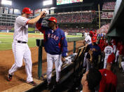 ARLINGTON, TX - OCTOBER 23: Derek Holland #45 of the Texas Rangers is congratulated by manager Ron Washington after the eighth inning during Game Four of the MLB World Series against the St. Louis Cardinals at Rangers Ballpark in Arlington on October 23, 2011 in Arlington, Texas. (Photo by Tom Pennington/Getty Images)