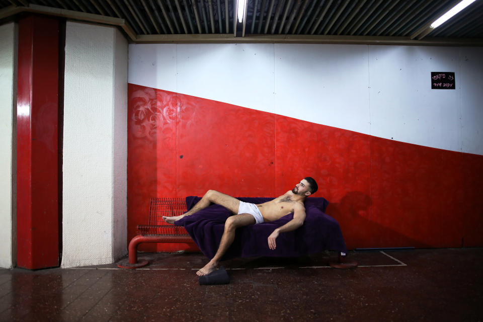 A model poses for an artist at the Central Bus Station on Jan. 11. (Photo: Corinna Kern/Reuters)