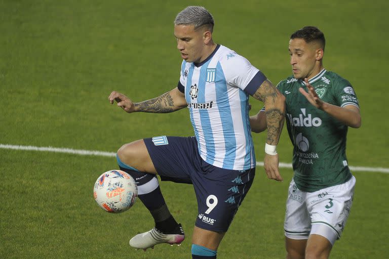 Enzo Copetti, de Racing, intenta controlar la pelota ante la marca de Facundo Castet, de Sarmiento