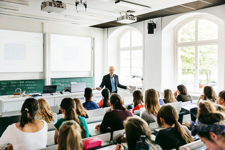 students sitting in class in a lecture hall