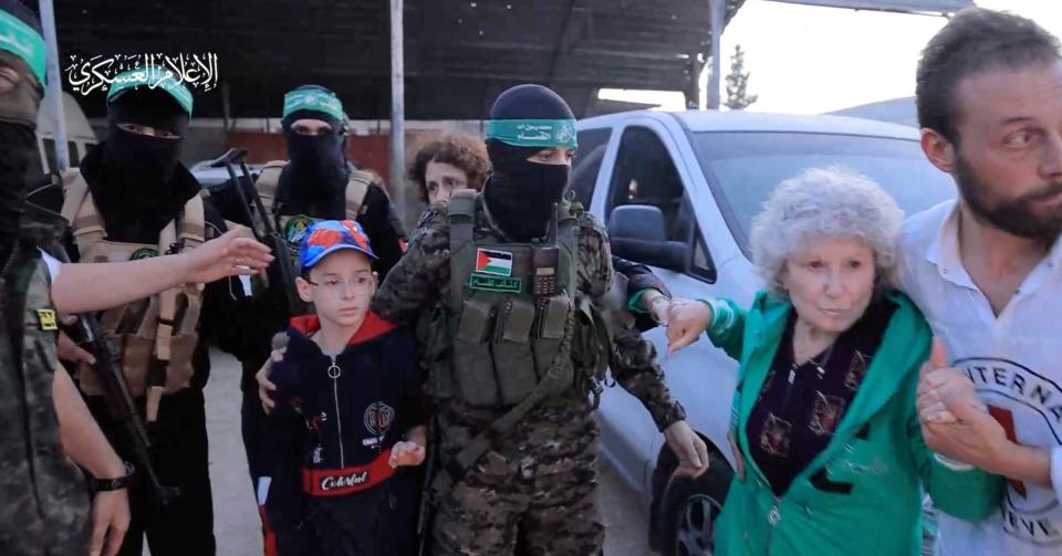 Hostages who were abducted by Hamas gunmen during the October 7 attack on Israel are handed over by Hamas militants to the International Red Cross, as part of a hostages-prisoners swap deal between Hamas and Israel amid a temporary truce, in an unknown location in the Gaza Strip, November 24, 2023.