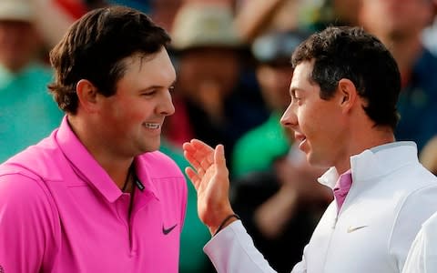 Patrick Reed, left, is congratulated by Rory McIlroy - Credit: AP