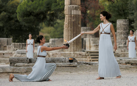 Olympics - Dress Rehearsal - Lighting Ceremony of the Olympic Flame Pyeongchang 2018 - Ancient Olympia, Olympia, Greece - October 23, 2017 Greek actress Katerina Lehou, playing the role of High Priestess, holds a torch during the dress rehearsal for the Olympic flame lighting ceremony for the Pyeongchang 2018 Winter Olympic Games at the site of ancient Olympia in Greece REUTERS/Alkis Konstantinidis