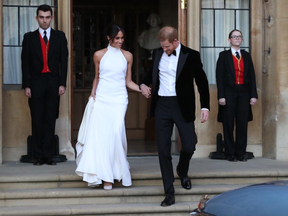 Duchess of Sussex and Prince Harry, Duke of Sussex leave Windsor Castle after their wedding to attend an evening reception at Frogmore House, hosted by the Prince of Wales on May 19, 2018 in Windsor, England.