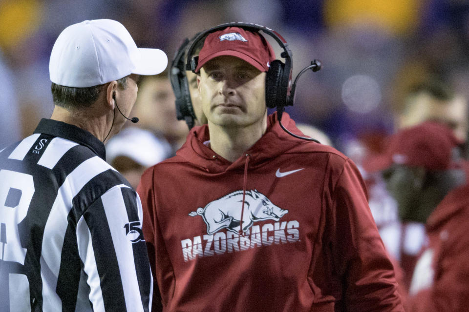 Arkansas coach Barry Lunney, Jr. talks to an official during the first half of the team's NCAA college football game against LSU in Baton Rouge, La., Saturday, Nov. 23, 2019. (AP Photo/Matthew Hinton)