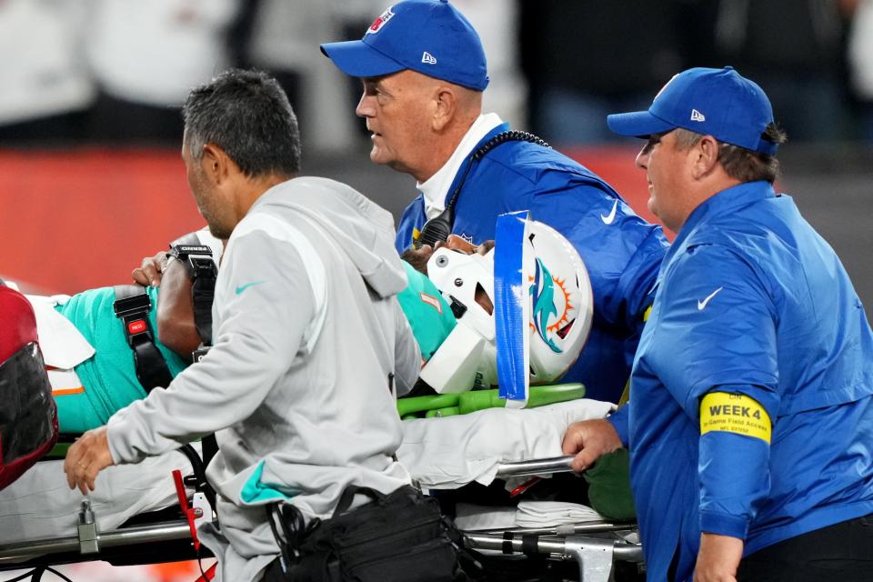 Miami Dolphins quarterback Tua Tagovailoa is taken off the field after suffering a head injury.