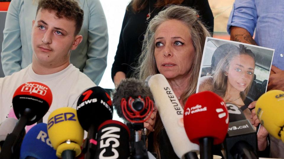 PHOTO: Keren Shem, the mother Mia Shem, held hostage by Hamas militants in Gaza, holds a photograph of her daughter as she speaks to the press in Tel Aviv on Oct. 17, 2023. (Gil Cohen Magen/AFP via Getty Images)