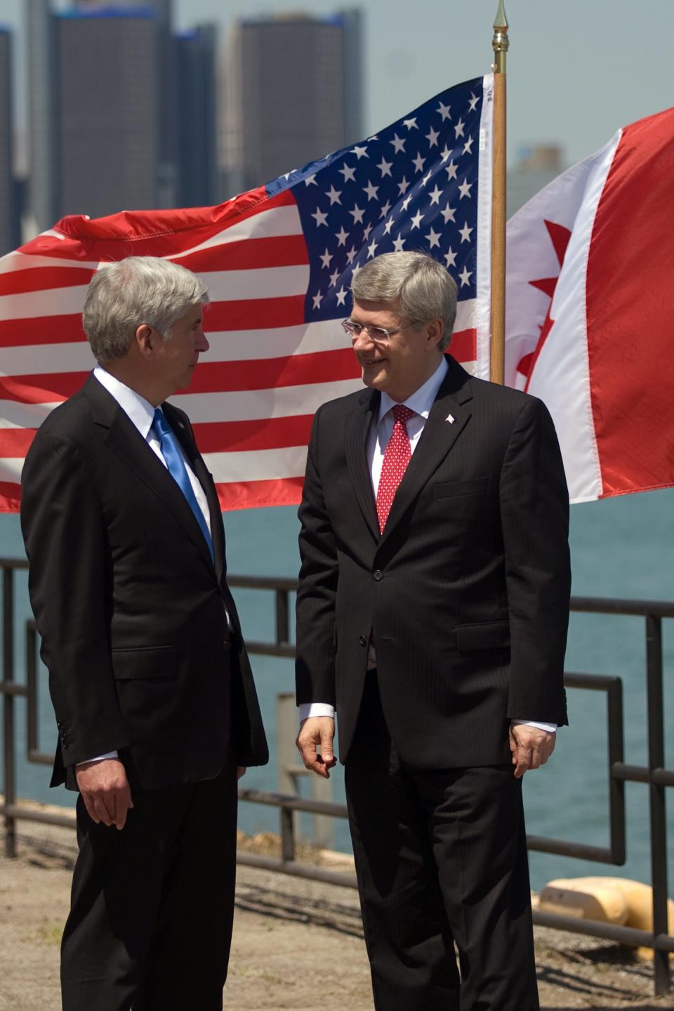 Prime Minister Stephen Harper right, and Michigan Governor Rick Snyder chat on the banks of the Detroit River in Windsor, Ontario, Canada, on Friday, June 15, 2012, ahead of an announcement for a new $1-billion bridge connecting the city with Detroit. (AP Photo/The Canadian Press, Mark Spowart )