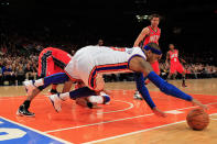 Carmelo Anthony (front) dives for a ball against the New Jersey Nets at Madison Square Garden on February 20, 2012 in New York . (Photo by Chris Trotman/Getty Images)