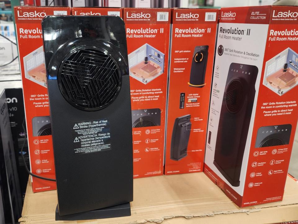 Lasko revolution heater next to red boxes with heater on packaging