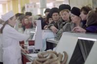 FILE - Muscovites queue to buy meat at a butcher shop in downtown Moscow, Dec. 27, 1990. Each Muscovite holds a special coupon which gives them the opportunity to by half a kilo of meat. (1.1 lbs.) at a time. It was an exciting, hopeful time for Soviet citizens and the world. Gorbachev brought the promise of a better future. (AP Photo/Alexander Zemlianichenko, File)