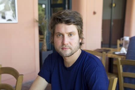 Vegard Groeslie Wennesland, a survivor of the July 22, 2011 shooting at Utoeya, poses for a photo at a cafe in Oslo, July 11, 2014. REUTERS/Gwladys Fouche