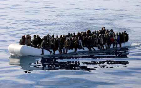 Migrants are seen in a rubber dinghy as they are rescued by Libyan coast guards in the Mediterranean Sea off the coast of Libya, January 15, 2018. Picture taken January 15, 2018. REUTERS/Hani Amara/Files