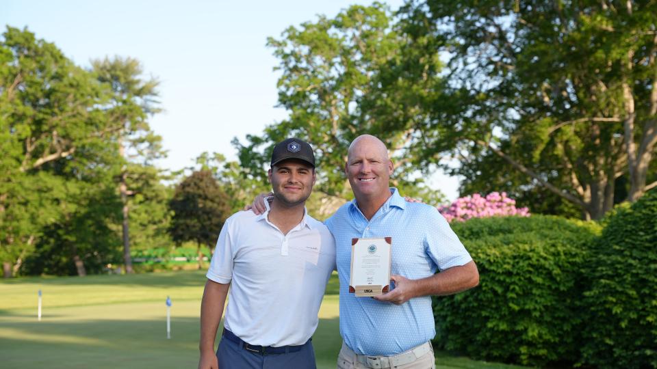 Brendan Hester poses with his son Jack, left, after he qualified for the US Senior Open.  Jack Hester caddied for his father in the round.