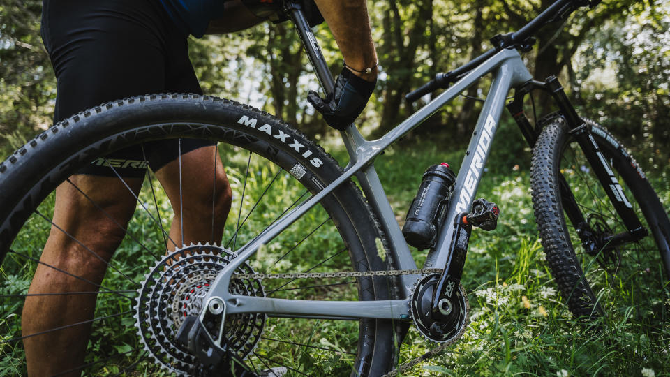 Rider adjusting the seatpost on a Merida Big Nine