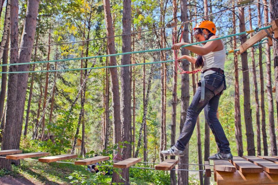 girls walking over a ropes course 