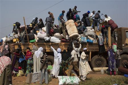 People load their belongings onto a truck as they prepare to leave during a repatriation by road to Chad at the capital Bangui January 16, 2014. REUTERS/Siegfried Modola