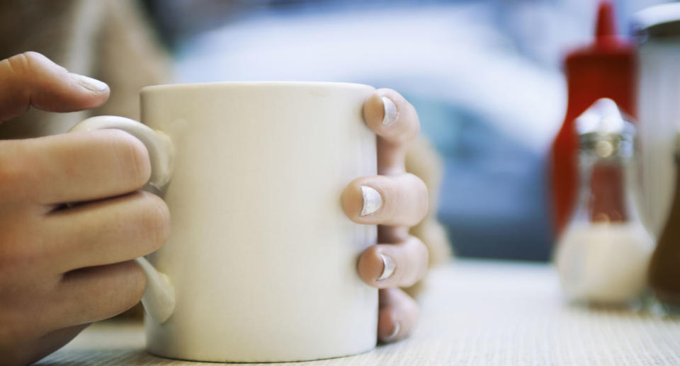 A Florida teacher has shared a hilarious misunderstanding she had with her class. Pictured is a stock image of a woman's hands around a coffee cup.