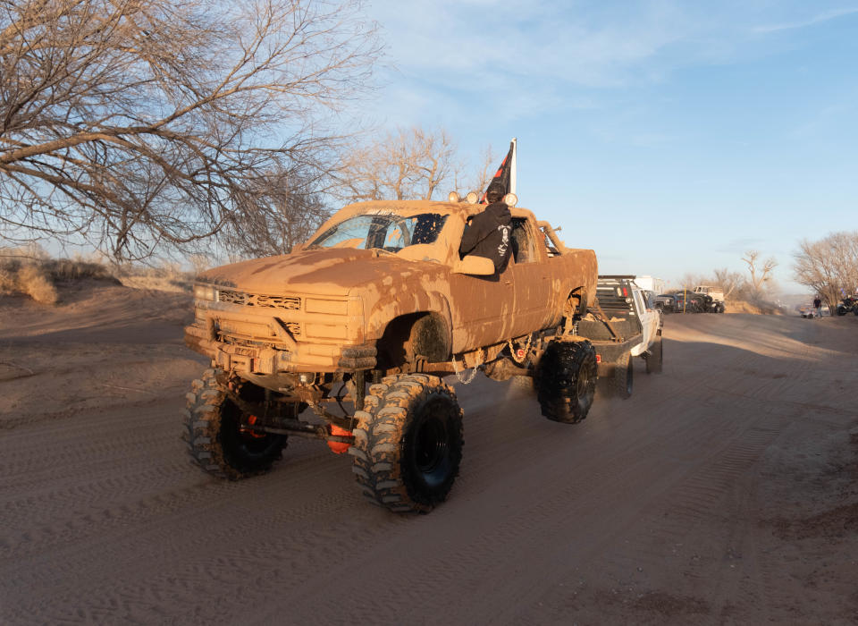 A truck is towed at the annual Sand Dregs event Saturday at the Canadian River north of Amarillo.