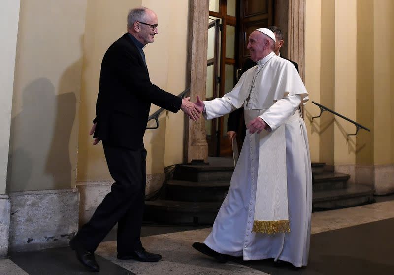 FILE PHOTO: Pope Francis shakes hands with Under-Secretary of the Migrants and Refugees Section of the Dicastery for Promoting Integral Human Development, Michael Czerny, during an audience with refugees arriving from Lesbos at the Vatican