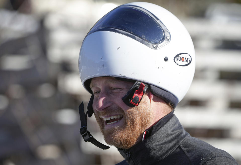 Prince Harry, the Duke of Sussex, laughs after sliding down the track on a skeleton sled during an Invictus Games training camp, in Whistler, British Columbia, Thursday, Feb. 15, 2024. Invictus Games Vancouver Whistler 2025 is scheduled to take place from Feb. 8 to 16, 2025 and will for the first time feature winter sports. (Darryl Dyck/The Canadian Press via AP)