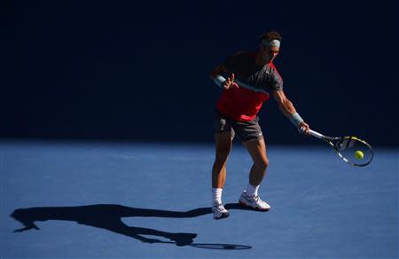 Rafael Nadal of Spain hits a return to Grigor Dimitrov of Bulgaria during their men's singles quarter-final tennis match at the Australian Open 2014 tennis tournament in Melbourne January 22, 2014. REUTERS/David Gray