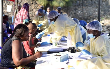 Congolese health workers collect data before administering ebola vaccines to civilians at the Himbi Health Centre in Goma