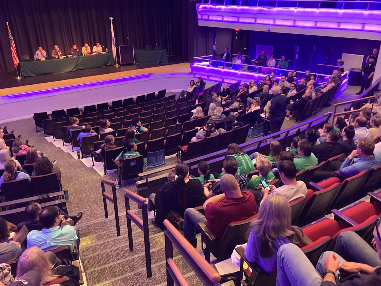 The Sutton School Committee meets before a crowd at the high school auditorium.