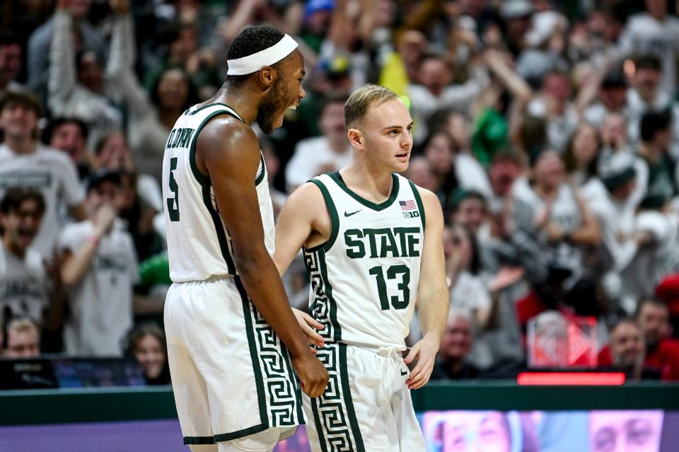 Michigan State's Steven Izzo, right, is congratulated by Tre Holloman after Izzo made a basket and drew a foul against Rutgers during the second half on Sunday, Jan. 14, 2024, at the Breslin Center in East Lansing.
