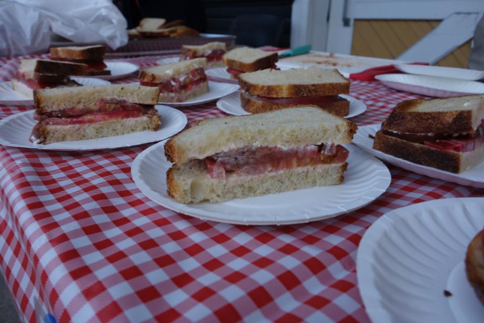 Freshly prepared tomato sandwiches sit on a table at the Hendersonville Farmers Market Tomato Day in 2021.