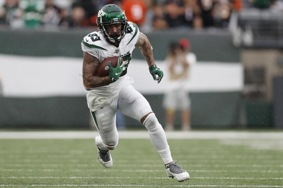 FILE - New York Jets tight end Tyler Conklin (83) runs the ball up the field during an NFL football game against the Cincinnati Bengals, Sunday, Sept. 25, 2022, in East Rutherford, N.J. Conklin had childhood dreams of the NBA hardwood while shooting jumpers and dunking at arenas all around the country. His journey took a few twists and dribbles and he ended up catching passes in NFL stadiums instead. (AP Photo/Steve Luciano, File)