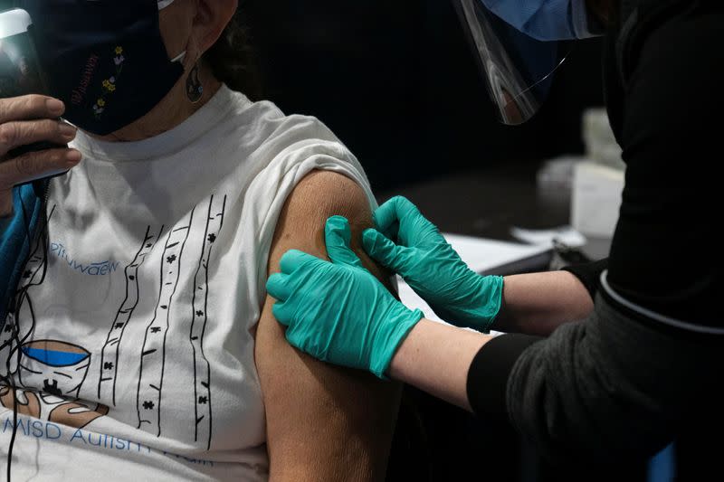 People from rural communities get their coronavirus disease (COVID-19) vaccinations at Menominee Indian High School in Menominee, Wisconsin