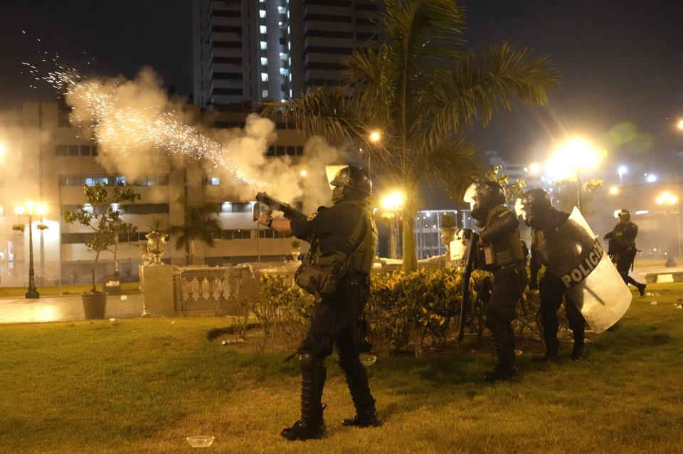 Riot police fire tear gas at anti-government protesters in Lima, Peru, Friday, Jan. 20, 2023. Protesters are seeking the resignation of President Dina Boluarte, the release from prison of ousted President Pedro Castillo and immediate elections. (AP Photo/Martin Mejia)