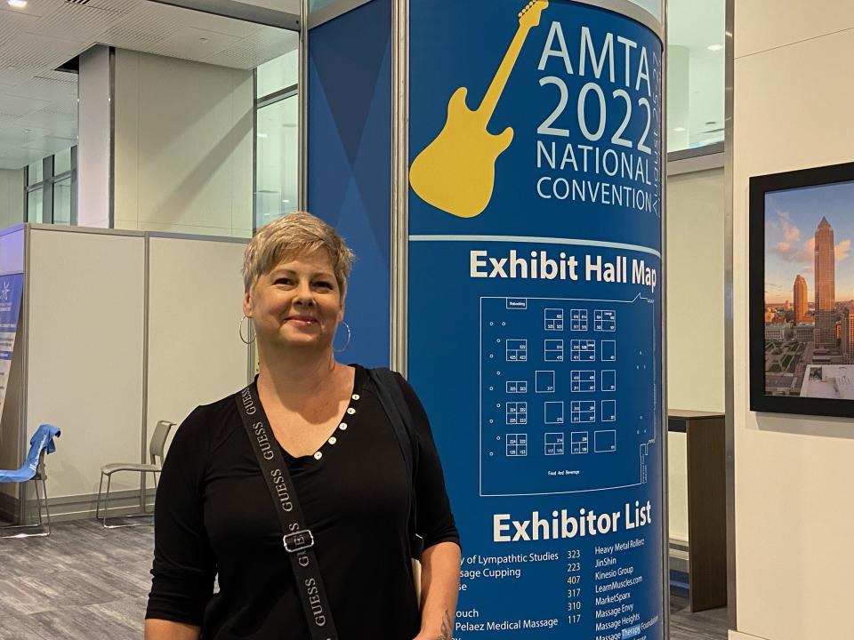 Mary Czech, 55, of Whitmore Lake, Mich., poses at the American Massage Therapist Association national convention at the Huntington Convention Center in Cleveland, Ohio, Wednesday, Aug. 24, 2022. Therapists at the conference are focusing on education, vetting potential customers and setting the boundaries they can enforce. Czech said she has always had a plan of escape over her 20 years as a therapist, including knowing where the closest phone and police department are in case a client engages in inappropriate behavior. (AP Photo/Teresa Walker)