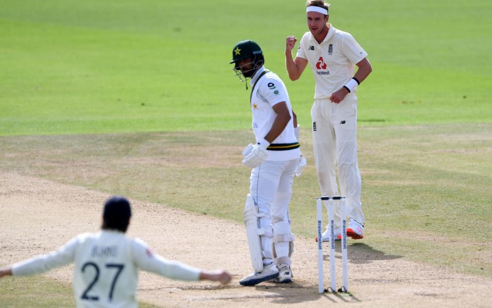 Stuart Broad (right) celebrates dismissing Pakistan's Shan Masood LBW - PA