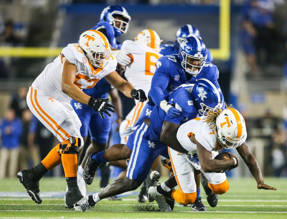 UK defensive linemen Octavious Oxendine (8) and Josaih Hayes (97) sack Tennessee quarterback Joe Milton III (7) in the second half of Saturday's game at Kroger Field. The Cats made some stops but fell to Tennessee 33-27.