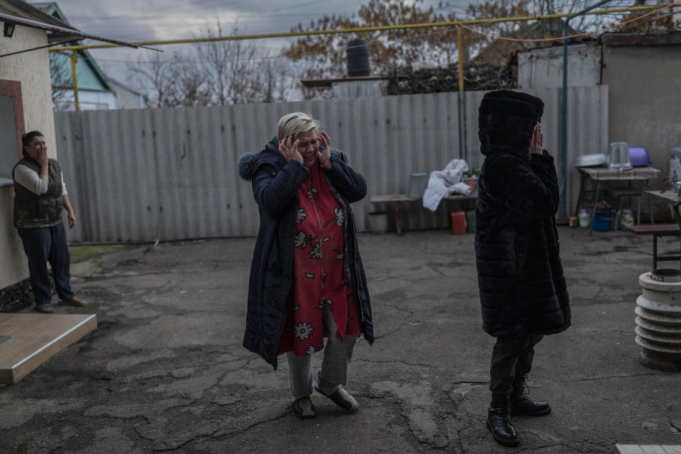 Natalia Voblikova, center, reacts after knowing that her son Artur was seriously injured after a Russian strike in Kherson, southern Ukraine, Tuesday, Nov. 22, 2022. Artur Voblikov, 13, was injured after a Russian strike, and doctors had to amputate his left arm. As attacks increase in the recently liberated city of Kherson, doctors are struggling to cope amid little water, electricity and a lack of equipment. (AP Photo/Bernat Armangue)