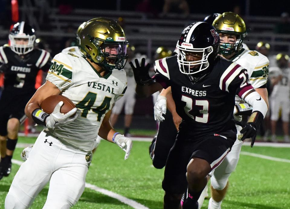 Vestal's Liam Nealy carries the ball as Julian Colon of Elmira comes up to go for the tackle during the Golden Bears' 27-0 win in football Oct. 6, 2023 at Elmira High School.