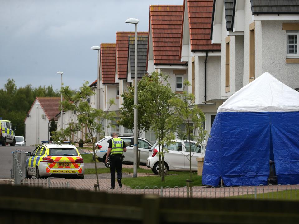 Police and forensic officers outside 61 Fairfeild Park, Monkton, Ayrshire, where Faulds from Kilmarnock was last seen alive (PA)