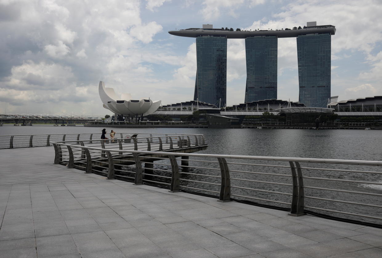 People take photos at Merlion Park in Singapore. 