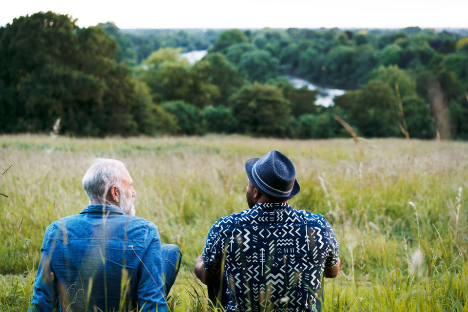 Two men in a field talking