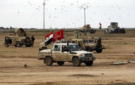 Shi'ite cleric Ahmed al-Rubaei sits in a vehicle in the town of Hamrin in Salahuddin province March 1, 2015. REUTERS/Thaier Al-Sudani