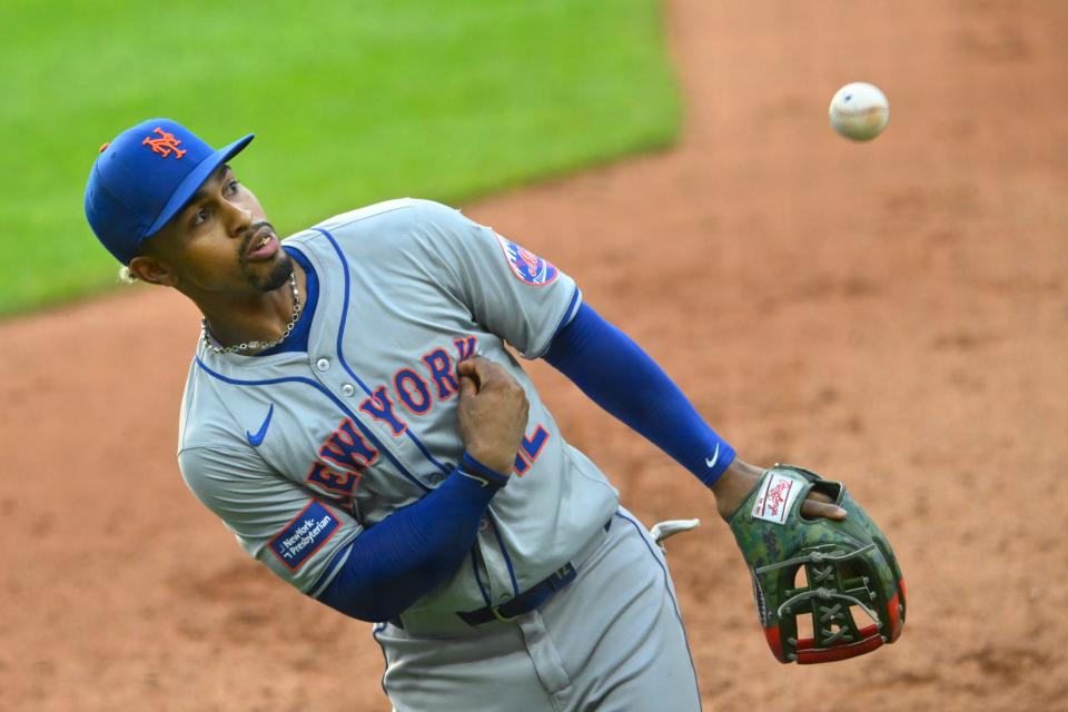 New York Mets shortstop Francisco Lindor (12) tosses a ball to the stands in the fourth inning against the Cleveland Guardians on Monday in Cleveland.