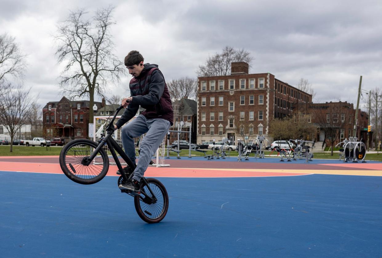 Nicholas Franco, 17, a Western International High School student, performs multiple wheelies at Clark Park in Detroit on Wednesday, April 3, 2024.