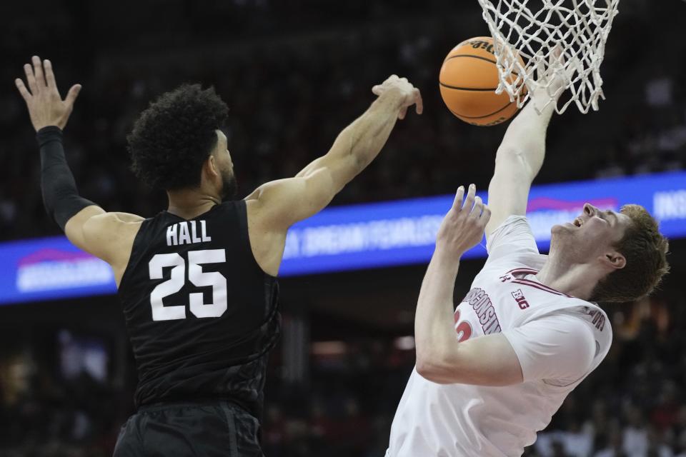 Michigan State's Malik Hall fouls Wisconsin's Steven Crowl during the second half of an NCAA college basketball game Friday, Jan. 26, 2024, in Madison, Wis. (AP Photo/Morry Gash)