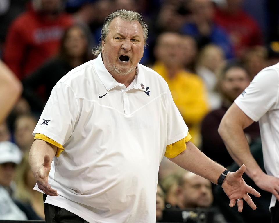 West Virginia head coach Bob Huggins talks to an official after being ejected from the game during the first half of an NCAA college basketball game against Kansas in the quarterfinal round of the Big 12 Conference tournament in Kansas City, Mo., Thursday, March 10, 2022. (AP Photo/Charlie Riedel)