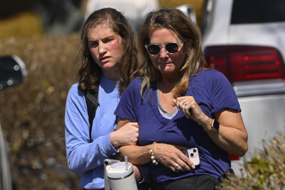 A family leave a reunification site in Nashville, Tenn., Monday, March 27, 2023 after several children were killed in a shooting at Covenant School in Nashville. The suspect is dead after a confrontation with police. (AP Photo/John Amis)